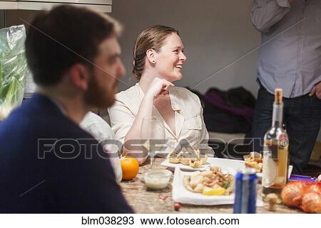 Friends enjoying dinner party View Large Photo Image Stock Image - Friends enjoying dinner party. Fotosearch