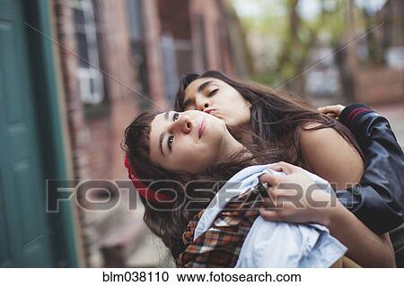 Friends kissing in city View Large Photo Image Stock Image - Friends kissing in city. Fotosearch