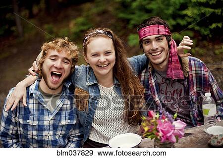 Friends laughing in forest View Large Photo Image Stock Photo - Friends laughing in forest. Fotosearch
