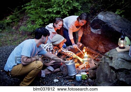 Friends roasting marshmallows over forest campfire View Large Photo Image Stock Image - Friends roasting marshmallows over forest campfire. Fotosearch