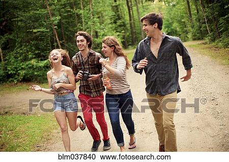 Friends running on dirt path in forest View Large Photo Image Stock Image - Friends running on dirt path in forest. Fotosearch
