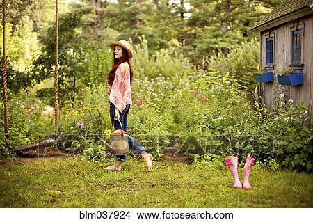 Picture - Gardener picking flowers in garden. Fotosearch
