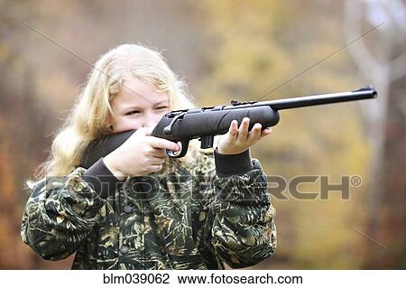 Girl in camouflage aiming rifle in forest View Large Photo Image Stock Image - Girl in camouflage aiming rifle in forest. Fotosearch