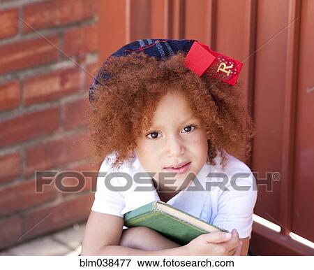 Stock Photo - Girl in school uniform holding book. Fotosearch