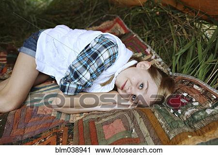 Girl laying on blanket in camping tent View Large Photo Image Stock Image - Girl laying on blanket in camping tent. Fotosearch
