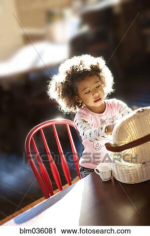 Girl opening basket at table View Large Photo Image Stock Image - Girl opening basket at table. Fotosearch