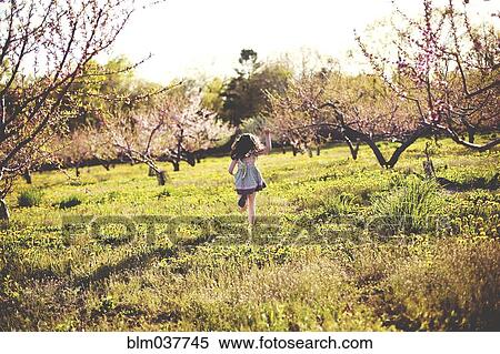 Girl playing in rural field View Large Photo Image Stock Photography - Girl playing in rural field. Fotosearch