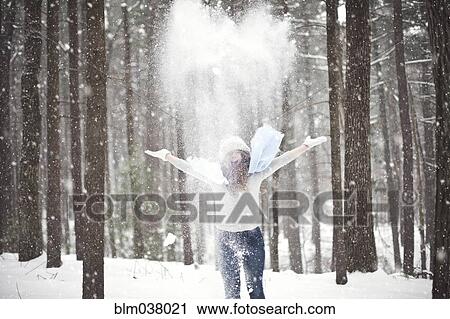 Girl playing in snowy forest View Large Photo Image Stock Image - Girl playing in snowy forest. Fotosearch