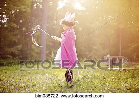 Girl playing princess in backyard View Large Photo Image Stock Image - Girl playing princess in backyard. Fotosearch