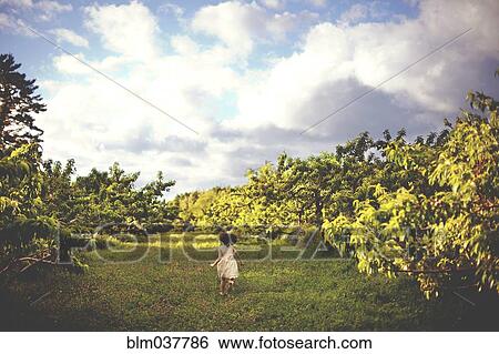Girl running in rural field View Large Photo Image Stock Photograph - Girl running in rural field. Fotosearch