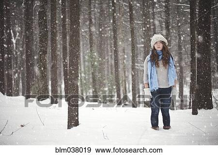 Girl standing in snowy forest View Large Photo Image Stock Photo - Girl standing in snowy forest. Fotosearch