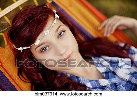 Picture - Girl wearing flower crown in hammock. Fotosearch