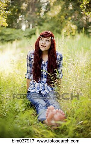 Stock Photo - Girl wearing flower crown in rural field. Fotosearch
