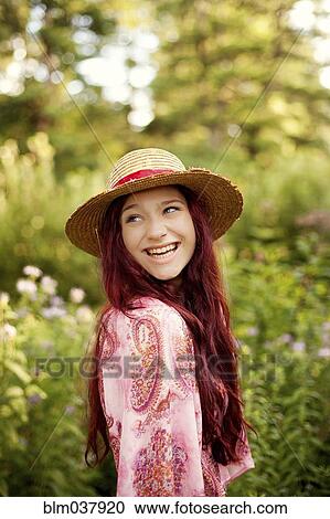 Girl wearing straw hat in garden View Large Photo Image Stock Image - Girl wearing straw hat in garden. Fotosearch