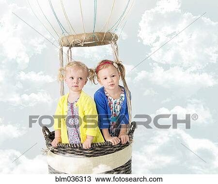 Girls playing in pretend hot air balloon View Large Photo Image Stock Image - Girls playing in pretend hot air balloon. Fotosearch