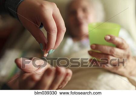 Granddaughter giving grandmother medication in bed View Large Photo Image Stock Image - Granddaughter giving grandmother medication in bed. Fotosearch