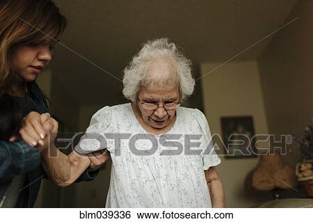 Granddaughter helping grandmother stand View Large Photo Image Stock Photograph - Granddaughter helping grandmother stand. Fotosearch
