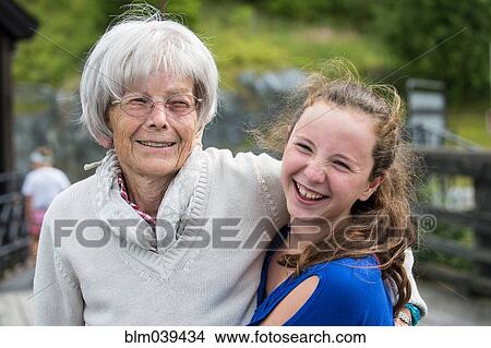Grandmother and granddaughter hugging at park View Large Photo Image Picture - Grandmother and granddaughter hugging at park. Fotosearch