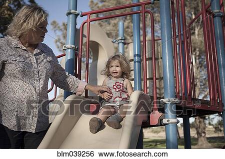 Grandmother and granddaughter playing at playground View Large Photo Image Stock Photograph - Grandmother and granddaughter playing at playground. Fotosearch