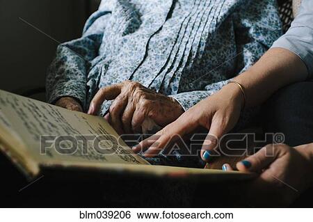 Grandmother and granddaughter reading book View Large Photo Image Stock Photograph - Grandmother and granddaughter reading book. Fotosearch