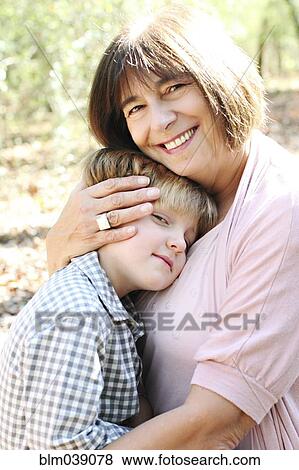 Grandmother and grandson hugging in forest View Large Photo Image Stock Photo - Grandmother and grandson hugging in forest. Fotosearch