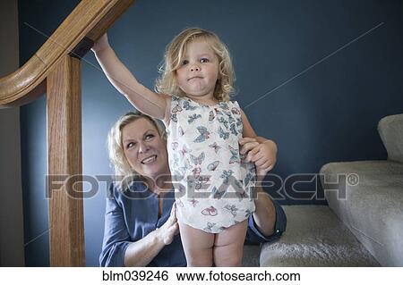 Stock Photograph - Grandmother helping granddaughter on staircase. Fotosearch