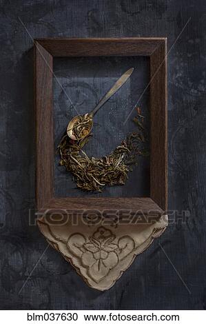 Stock Image - Herbs and spoon in picture frame. Fotosearch