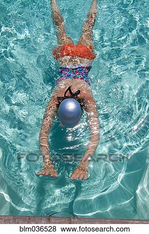 High angle view of Caucasian woman swimming in pool View Large Photo Image Stock Photo - High angle view of Caucasian woman swimming in pool. Fotosearch