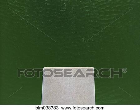 Stock Image - High angle view of empty diving board over lake. Fotosearch