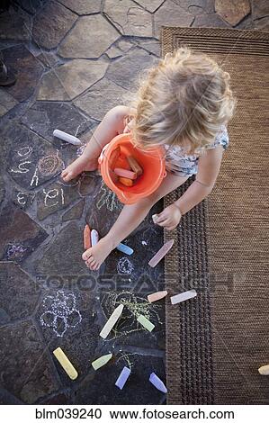 High angle view of girl drawing with chalk on tile View Large Photo Image Stock Image - High angle view of girl drawing with chalk on tile. Fotosearch