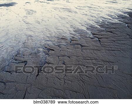 Stock Photo - High angle view of waves on beach. Fotosearch