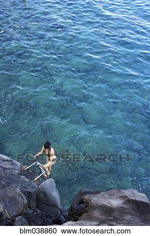 High angle view of woman climbing ladder out of ocean View Large Photo Image Stock Image - High angle view of woman climbing ladder out of ocean. Fotosearch