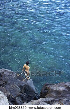 High angle view of woman climbing ladder into ocean View Large Photo Image Stock Photo - High angle view of woman climbing ladder into ocean. Fotosearch