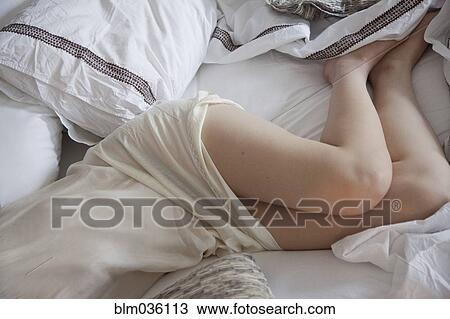 High angle view of woman laying in bed View Large Photo Image Stock Image - High angle view of woman laying in bed. Fotosearch