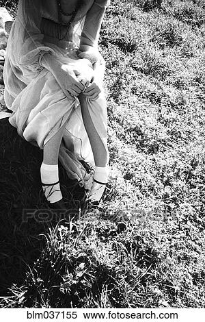 Stock Photography - High angle view of woman sitting in grass. Fotosearch