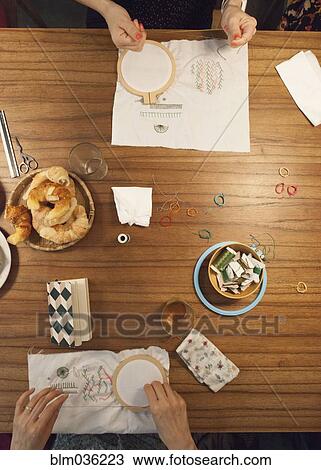 High angle view of women hand-stitching embroidery View Large Photo Image Stock Image - High angle view of women hand-stitching embroidery. Fotosearch