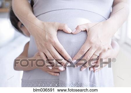 Hispanic girl holding belly of pregnant mother View Large Photo Image Stock Image - Hispanic girl holding belly of pregnant mother. Fotosearch