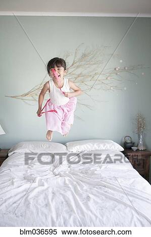Hispanic girl jumping on bed View Large Photo Image Stock Photography - Hispanic girl jumping on bed. Fotosearch