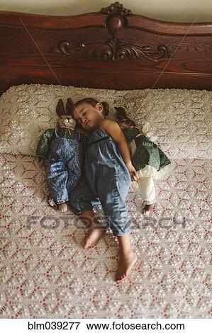 Hispanic girl napping on bed View Large Photo Image Stock Photo - Hispanic girl napping on bed. Fotosearch