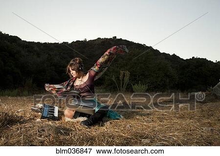 Stock Photo - Hispanic musician playing keyboard in field. Fotosearch