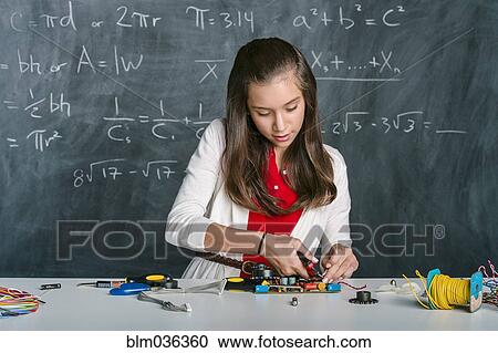 Hispanic student building vehicle in science class View Large Photo Image Stock Image - Hispanic student building vehicle in science class. Fotosearch