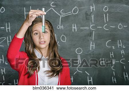 Hispanic student examining test tube in science class View Large Photo Image Stock Image - Hispanic student examining test tube in science class. Fotosearch