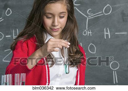 Hispanic student examining test tube in science class View Large Photo Image Stock Image - Hispanic student examining test tube in science class. Fotosearch