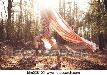 Hispanic woman running with scarf in forest View Large Photo Image Stock Image - Hispanic woman running with scarf in forest. Fotosearch