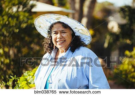 Hispanic woman smiling in backyard View Large Photo Image Stock Photography - Hispanic woman smiling in backyard. Fotosearch