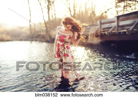 Hispanic woman standing in rural lake View Large Photo Image Stock Image - Hispanic woman standing in rural lake. Fotosearch