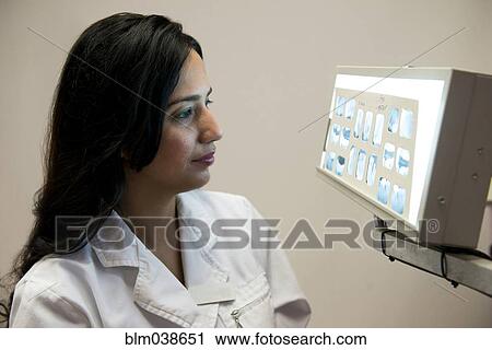 Indian dentist examining x-rays View Large Photo Image Stock Image - Indian dentist examining x-rays. Fotosearch