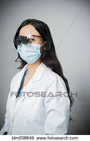 Indian dentist in surgical mask wearing binoculars View Large Photo Image Stock Photo - Indian dentist in surgical mask wearing binoculars. Fotosearch