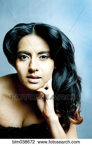 Stock Image - Indian woman resting chin in hand. Fotosearch