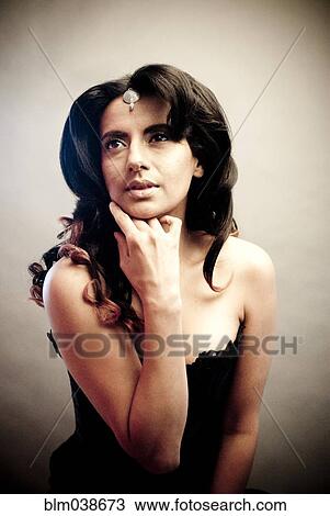 Indian woman resting chin in hand View Large Photo Image Stock Image - Indian woman resting chin in hand. Fotosearch